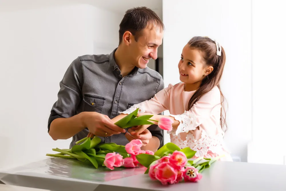 fathers day gifting flowers by daughter girl